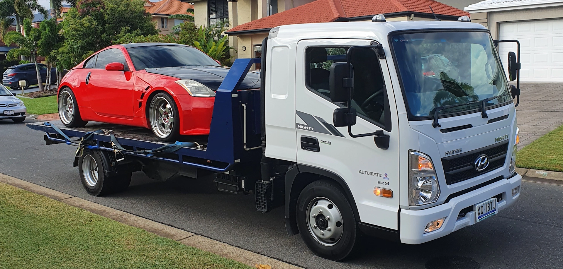 Red Nissan 350Z sports car being towed in Capalaba QLD