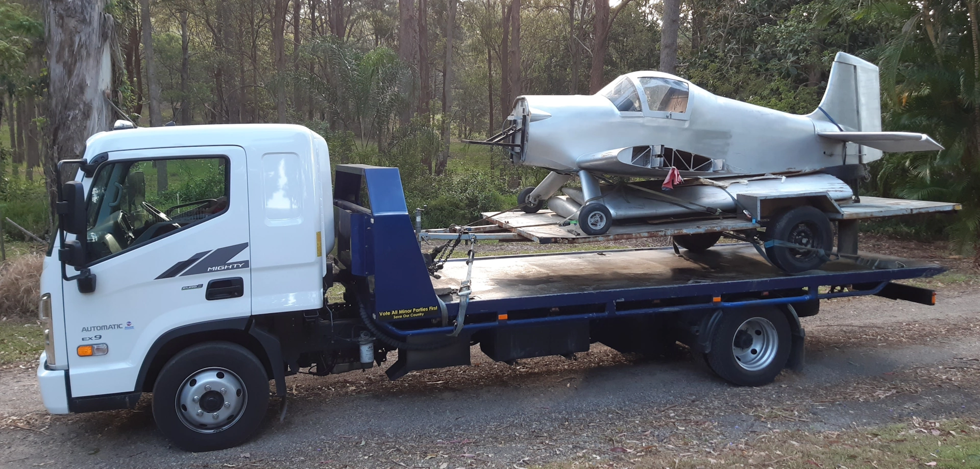A Silver Prop Plane being towed in Redland Bay