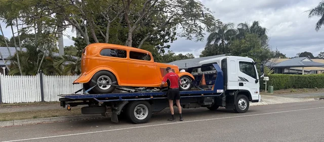 Orange hot rod secured on the Advanced Blue Towing tilt tray