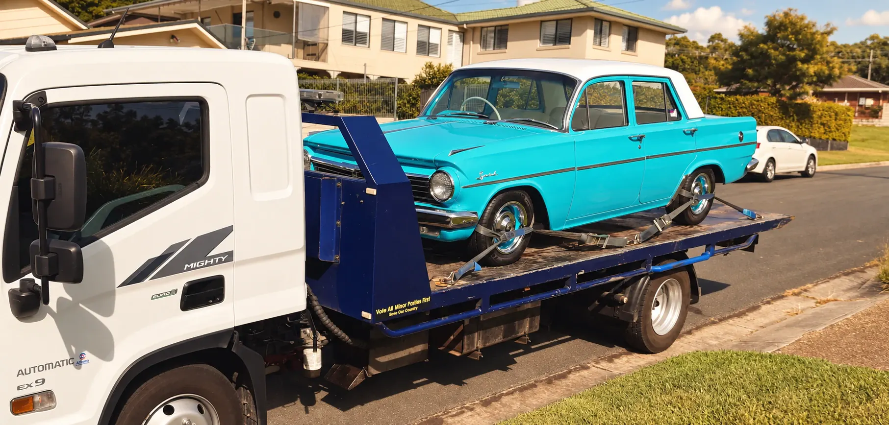 A turquoise classic Holden carefully transported on the Advanced Blue Towing tilt tray